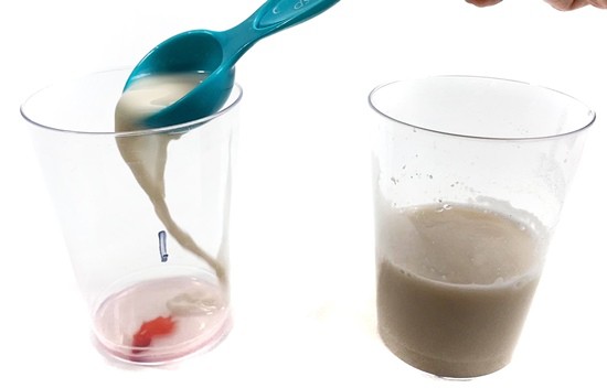 A person pours one tablespoon of yeast solution into a cup labeled '1'
