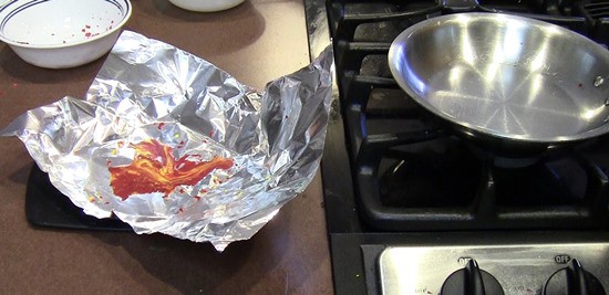Melted crayons on aluminum foil cooling off on the counter. 