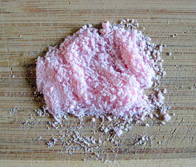 Tablets are crushed into a coarse pink powder