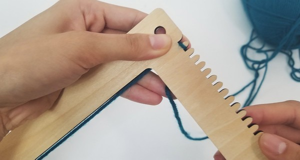 Loom's warp being threaded. 