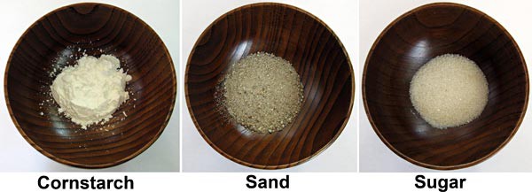 Three bowls contain cornstarch, sand and sugar