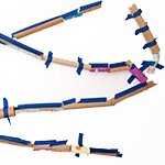 Wall marble run made from cardboard tubes and empty toilet paper rolls and tape