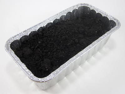 Aluminum bread pan filled with soil
