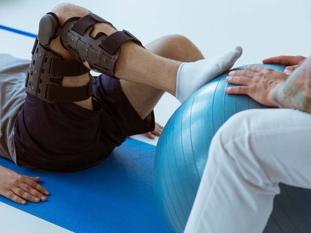 person with knee brace doing exercises