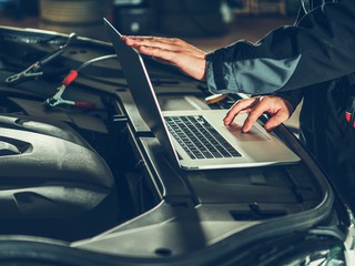 Vehicle Computer Checkup and Engine Software Update by Professional Auto Service Technician