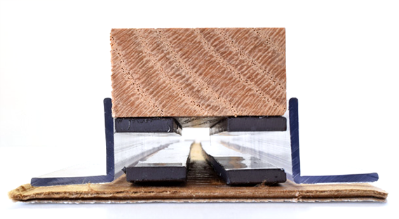 Model maglev train made from wood and magnetic strips floating above magnetic track