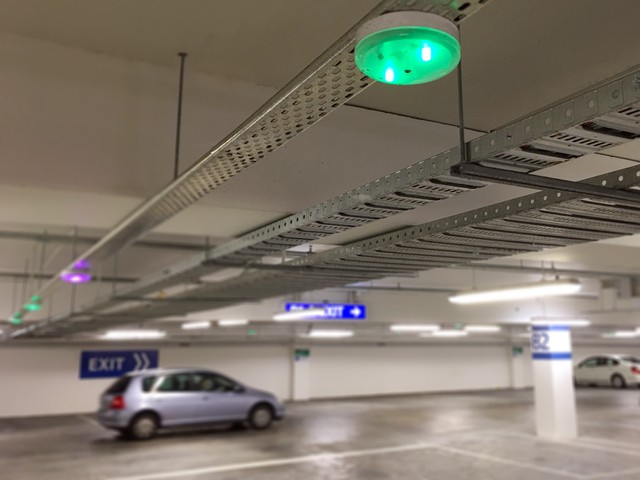 green parking abailability light on ceiling of garage