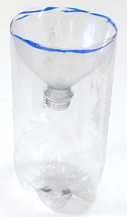 A two liter plastic bottle with the top section cut off and inserted upside down into the bottom section