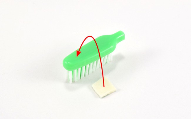 Stick foam tape to top of toothbrush.