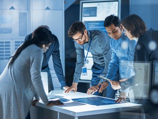 Group discussing and reviewing materials in a meeting