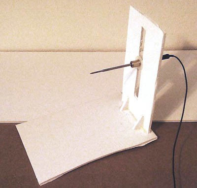 A thermometer probe mounted horizontally in a vertical foam board