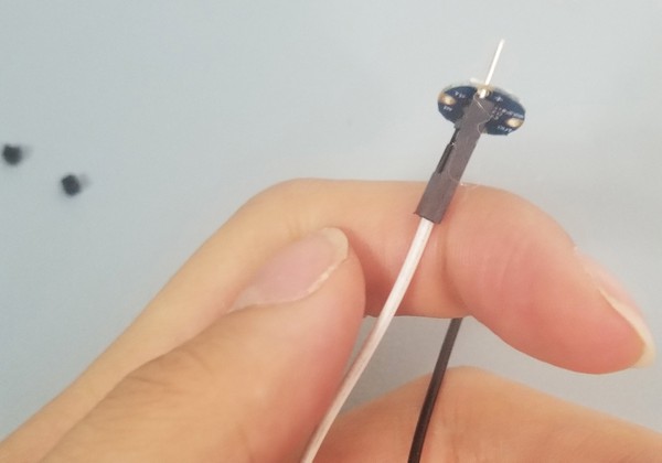 Male side of jumper wire through RGB LED. 