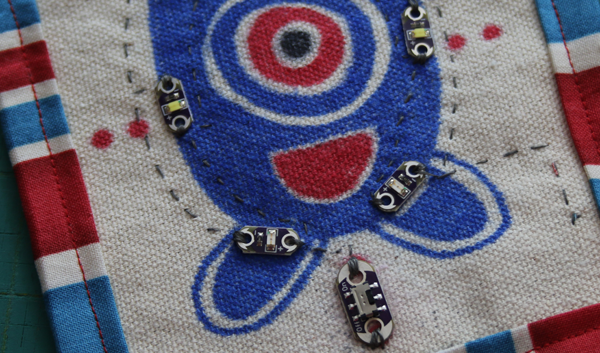 Five LilyPad LEDs sewn into a cloth fabric