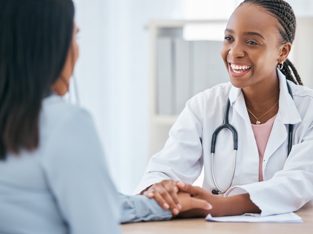 nurse Practitioner holding hands of patient