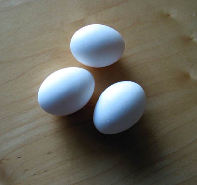 Three eggs lay on a table