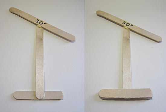 Two halves of a popsicle stick are glued perpendicular to the base of a popsicle stick support