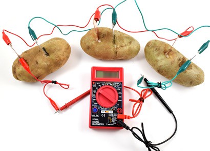 Three potatoes each with zinc and copper electrodes are wired in parallel with a multimeter