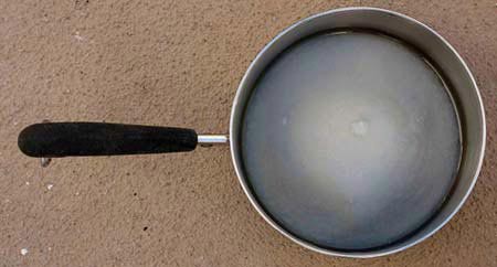 Small saucepan containing water, sugar, and corn syrup