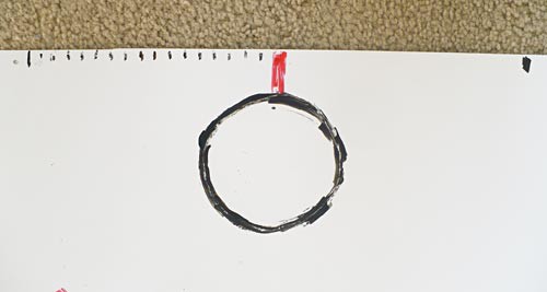 A circle is drawn at the top of a poster board to represent a basket