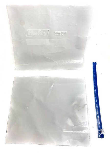 A Hefty bag cut into three pieces: the top zipper part, and the front and back plastic sheets of the bag. 