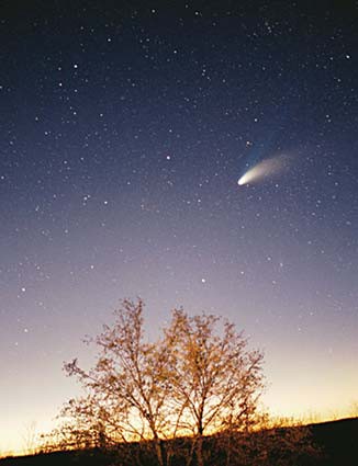 A comet streaking across the sky during a sunset