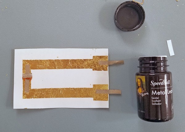 Sealer next to the metal leaf circuit tattoo. 
