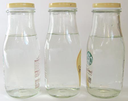 Three glass bottles are filled with an equal amount of water