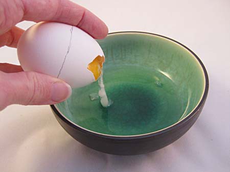 A hole is made near the top of an egg and its contents are poured out