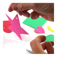 Student arranging mobile elements on homemade mobile to balance them - Art Science Experiments
