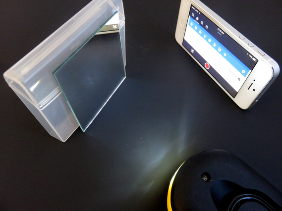 Setup with mirror, light, and mobile phone with sensor app