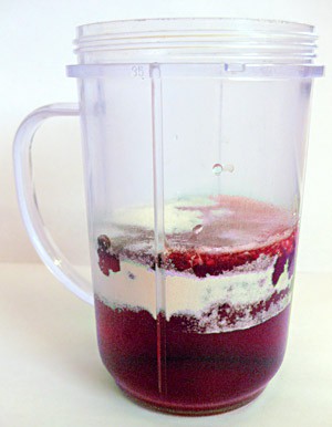 Water, sodium alginate and red food coloring are added to a blender cup
