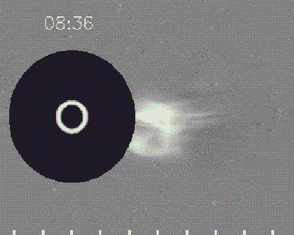 A coronagraph shows a large white flare emerging from the surface of the Sun with a timestamp of 8:36