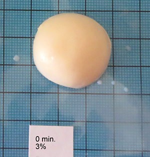 Top-down photo of a scoop of ice cream on a piece of blue graph paper
