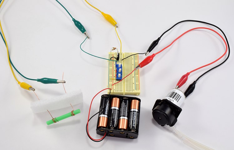 A completed insulin pump circuit with a breadboard, conductivity sensor, battery pack and peristaltic pump