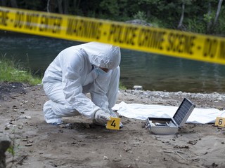 forensic scientist collecting evidence from a police crime scene