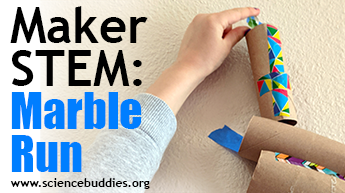 Makerspace STEM: student dropping marble into a marble run made of toilet paper tubes