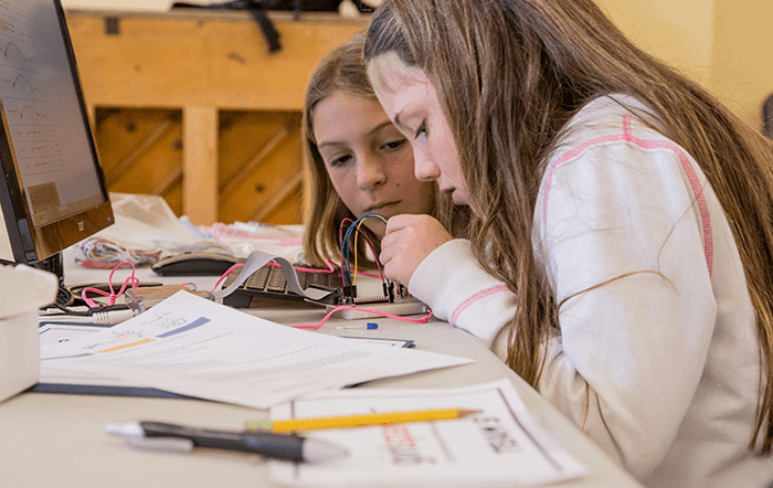 Girls at a GirlSPARC event doing hands-on Raspberry Pi projects with Scratch coding and electronics