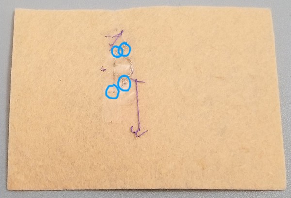 Back of base patch where hot glue spots are highlighted. 