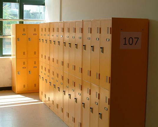 Rows of yellow metal lockers in a hallway