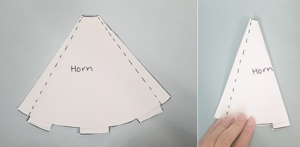 Horn paper template on felt. Horn paper template folded in half.