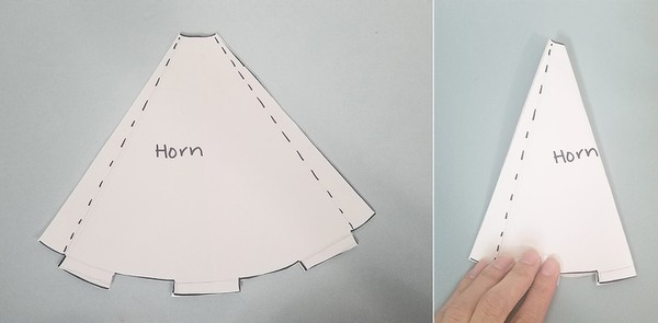 Horn paper template on felt. Horn paper template folded in half.