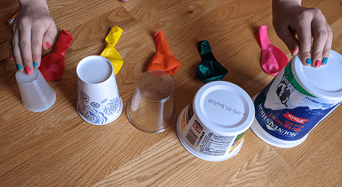 Row of plastic and paper containers and cups to be used for air cannon exploration