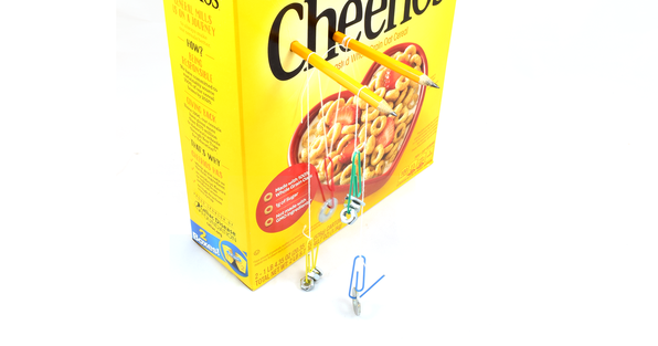 Single and compound pulleys set up using a cardboard box, pencils, paperclips, and string