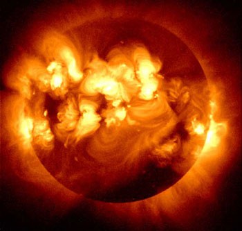 Composite image of a darkened sun with solar flares creating bright swirling patterns on the surface