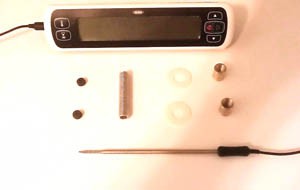 A thermometer probe, thermometer readout, two o-rings, two nylon washers, two lamp couplings and a lamp nipple