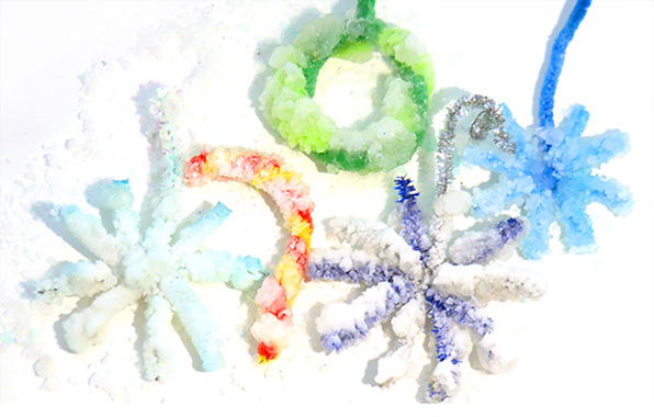Homemade crystals in winter shapes like a wreath, snowflake, and candy cane