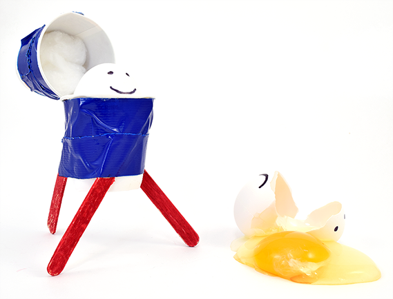 Egg lander made from straws and craft materials shown with cracked egg