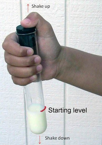 Milk in a test tube is capped and the level of the milk is marked