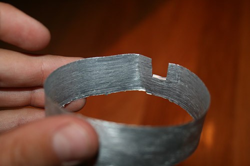 An aluminum ring has a small square notch cut from one of its sides
