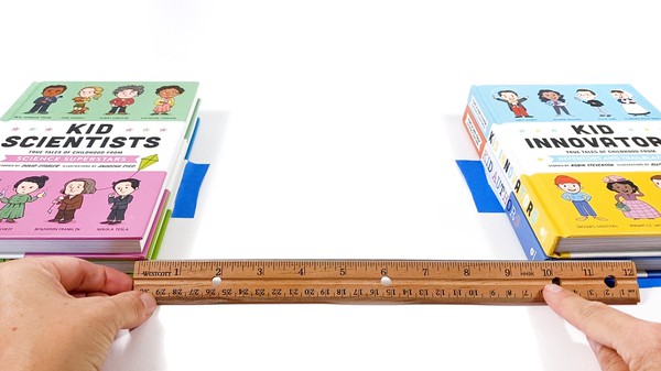 Two 2-inch-high stacks of books spaced about 10 inches apart. The location of the books is marked with tape.